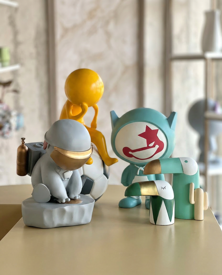 Curated figurine in a yellow dress and blue headband | Mapland
