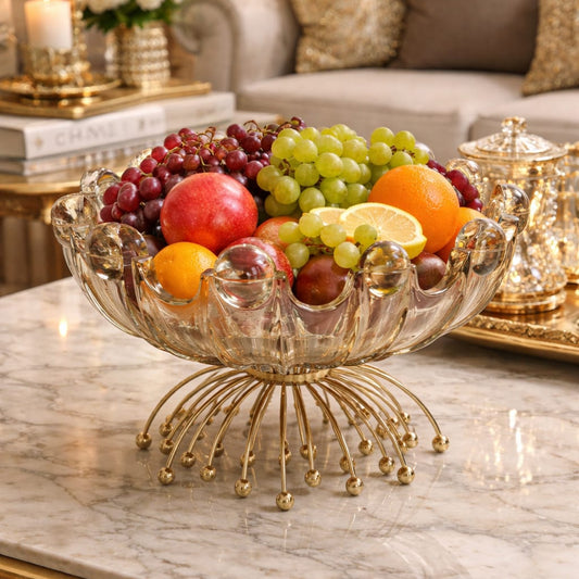 Decorative glass fruit bowl with fruits on a marble table in an elegant room.