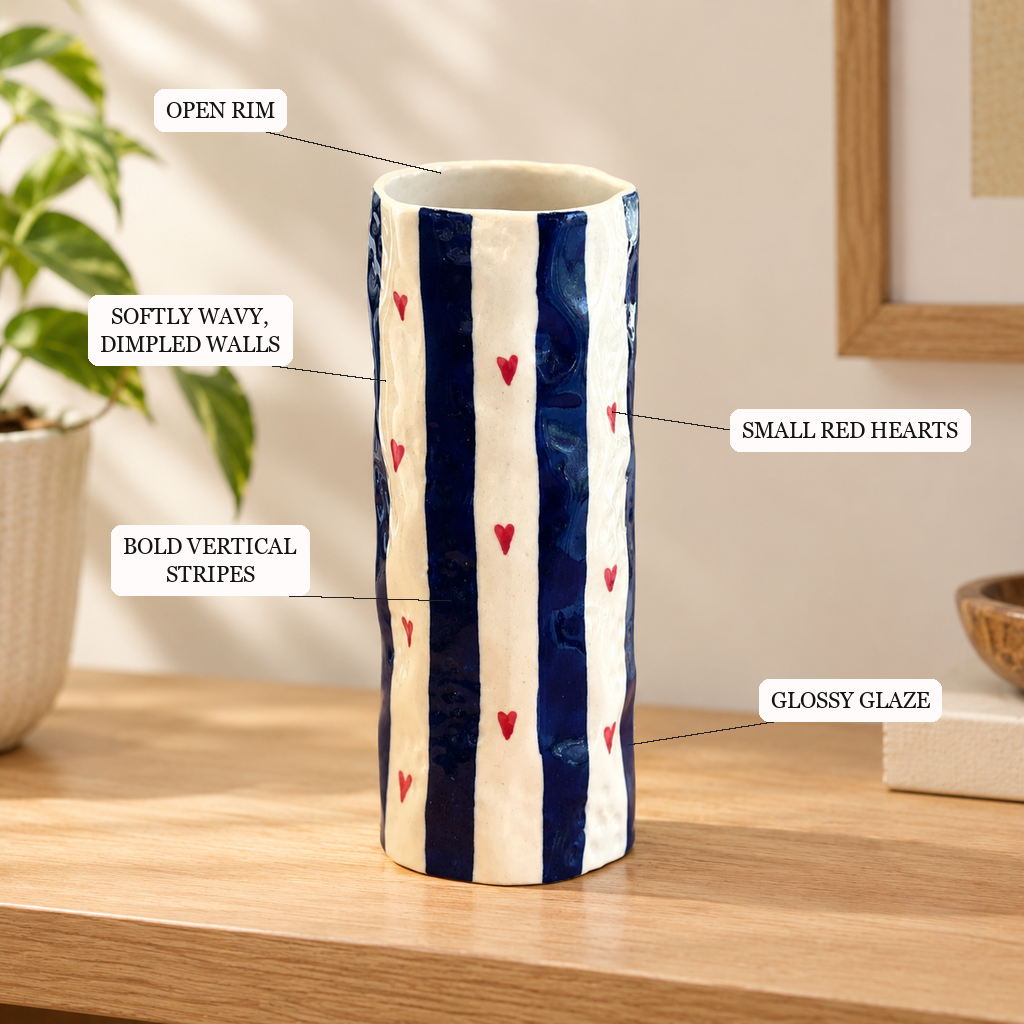 Heart Stripe Tumbler Vase features: open rim, softly wavy dimpled walls, bold vertical stripes, small red hearts, glossy glaze