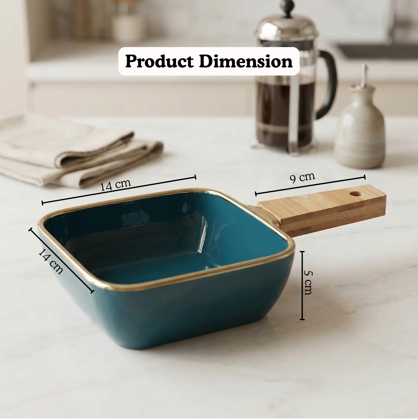 Teal square pan with wooden handle on a kitchen counter, showing dimensions.