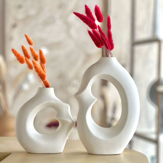 Modern Embrace Ceramic Vase Set showcasing abstract sculptures with dried flowers in a soft matte white finish.